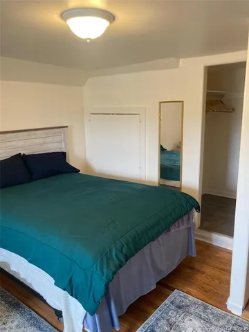 a living room with a bed furniture and a fireplace