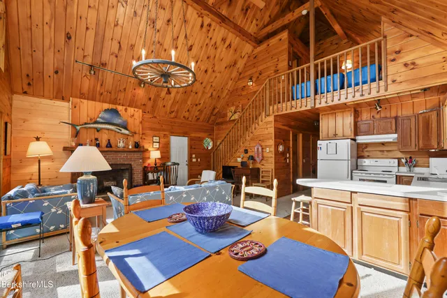 a view of a patio with table and chairs with wooden floor
