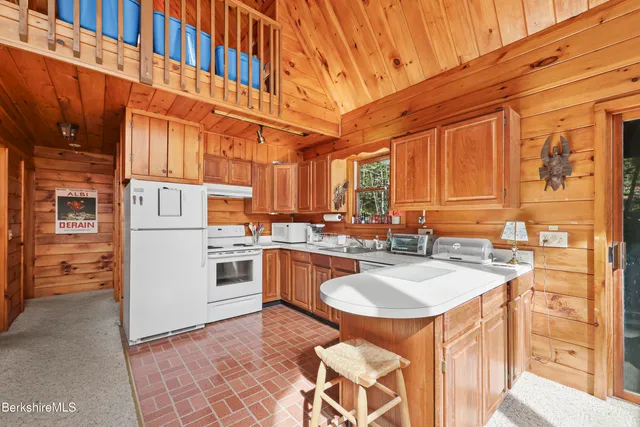 a kitchen with stainless steel appliances granite countertop a sink a stove and refrigerator