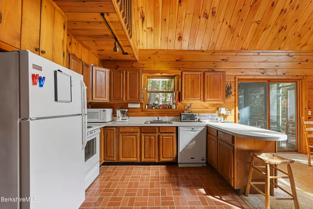 a kitchen with stainless steel appliances granite countertop a sink and cabinets