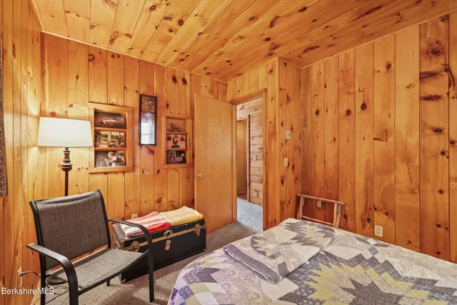 a bedroom with a bed and a chair