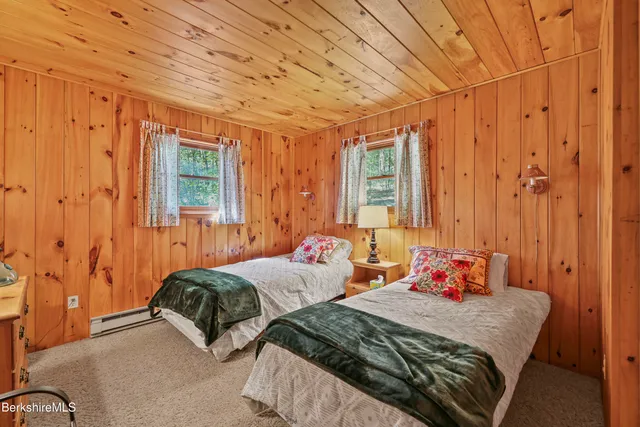 a bedroom with two beds and a window