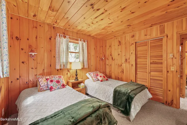 a bedroom with two beds and painted walls