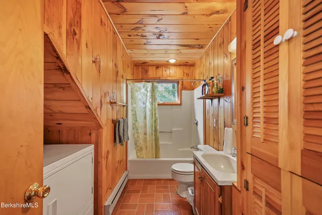 a bathroom with a toilet a sink and shower