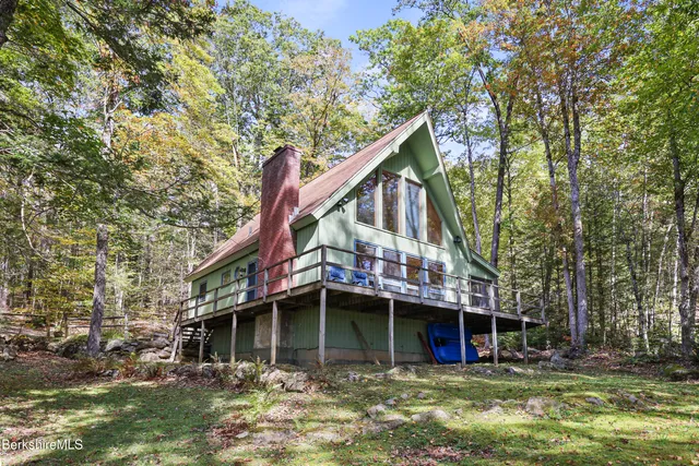 a view of a house with a yard and sitting area