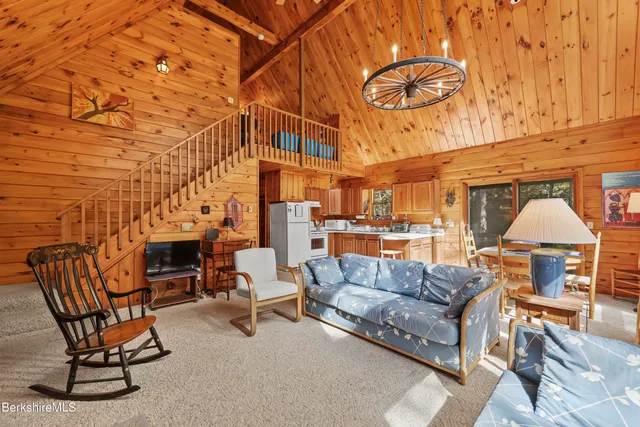 a living room with furniture a fireplace and city view