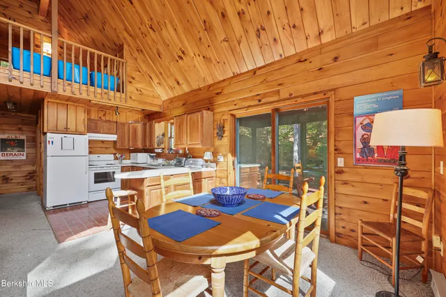 a dining room with furniture and a floor to ceiling window