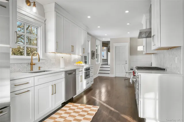 a kitchen with a refrigerator and a sink
