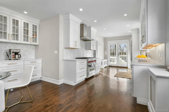 a kitchen with a wooden floor window and a view of living room