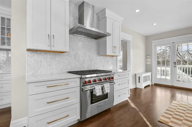 a kitchen with stainless steel appliances granite countertop a stove and a wooden cabinets