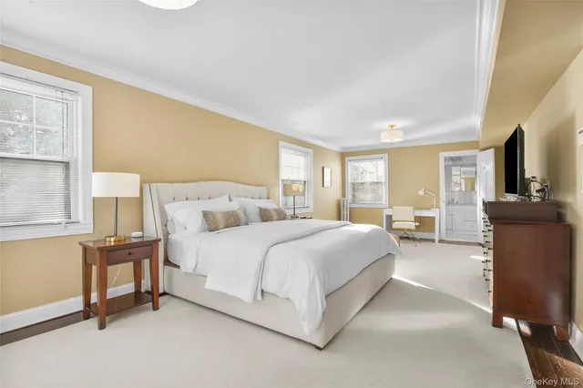 a spacious bedroom with a bed and window