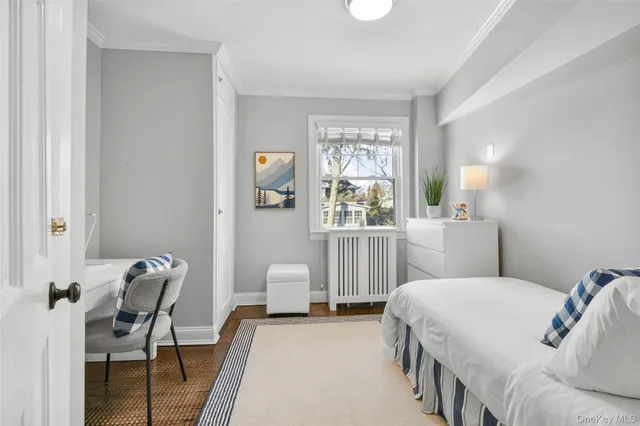 a bedroom with a bed a table and chair