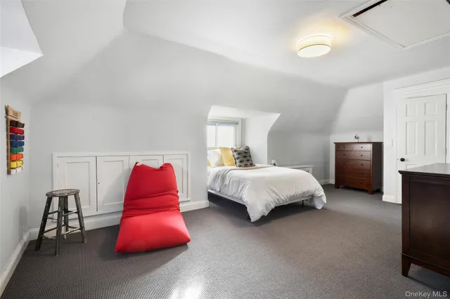 a bedroom with a bed and dresser