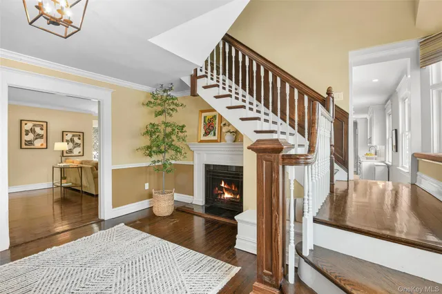 a living room with wooden floor and a fireplace