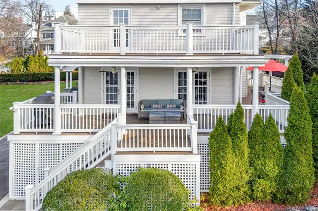 a view of a house with a yard and sitting area