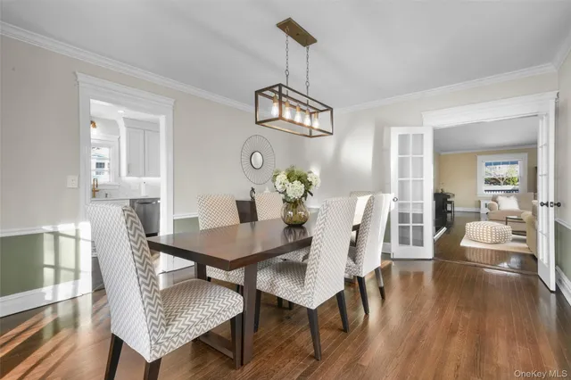 a view of a dining room with furniture wooden floor and chandelier