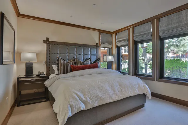 a bedroom with a large bed and a large window