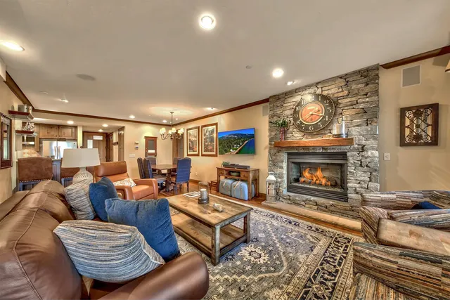 a living room with furniture a flat screen tv and a fireplace