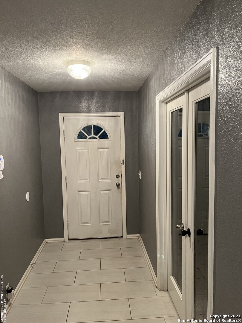 15710 Robin View San Antonio, TX 78255 - Photo 12 of 26 a view of a hallway to rooms