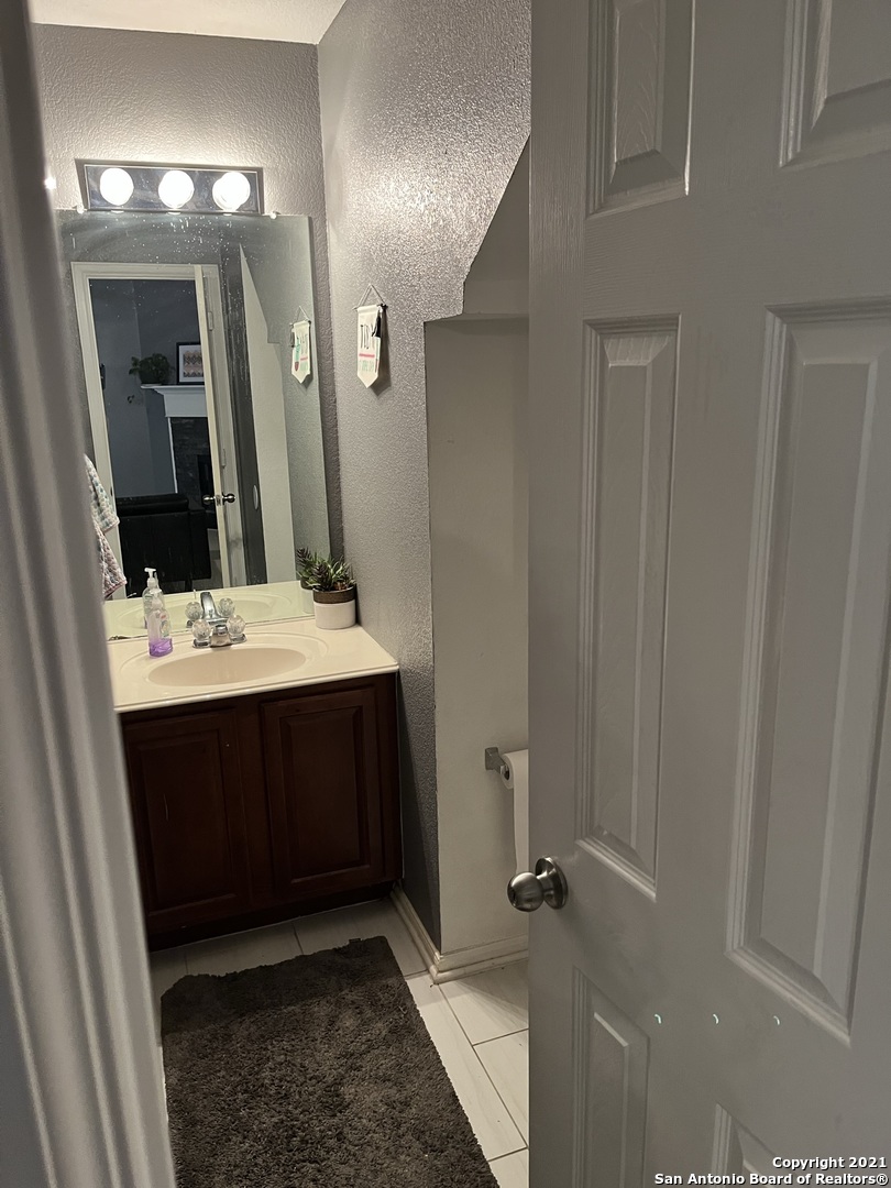 15710 Robin View San Antonio, TX 78255 - Photo 14 of 26 a bathroom with a sink and a mirror