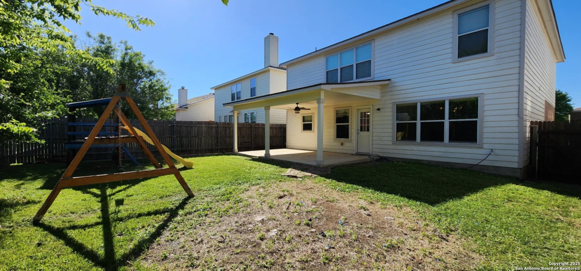 15710 Robin View San Antonio, TX 78255 - Photo 25 of 26 a view of a house with backyard and a tree