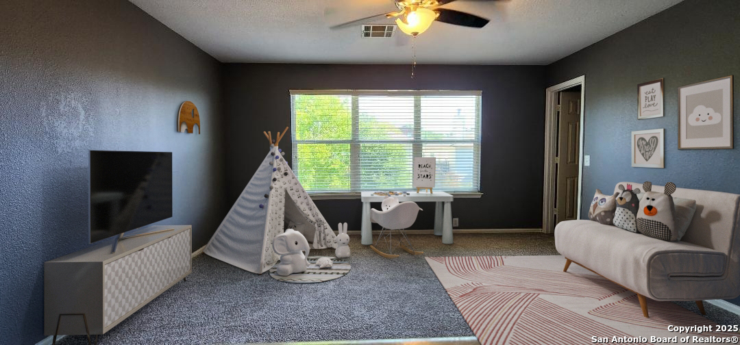 15710 Robin View San Antonio, TX 78255 - Photo 10 of 26 a living room with furniture and a flat screen tv
