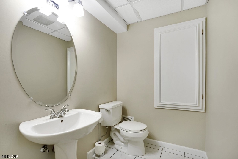 8 Hancock Court Bernards, NJ 07920 - Photo 20 of 25 a bathroom with a toilet sink and mirror