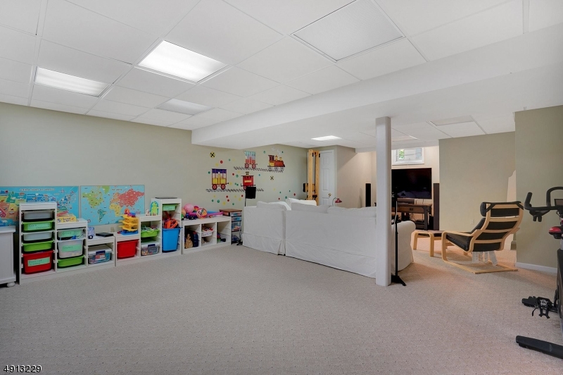 8 Hancock Court Bernards, NJ 07920 - Photo 22 of 25 a living room with furniture and a flat screen tv