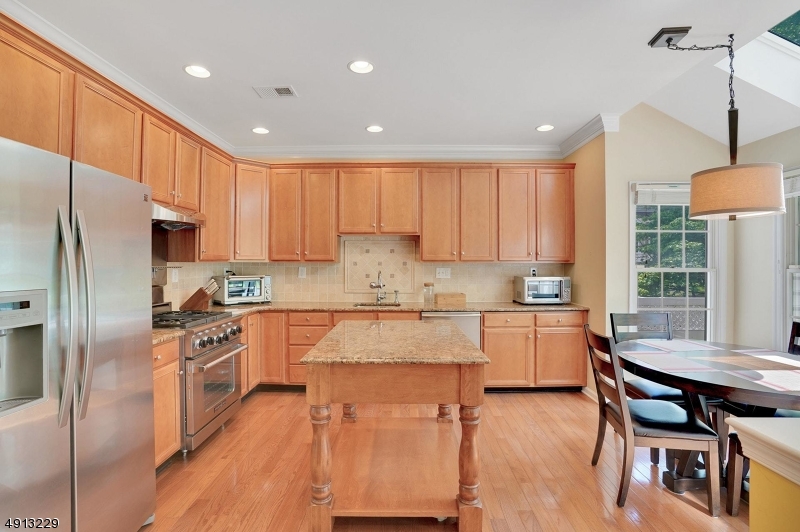 8 Hancock Court Bernards, NJ 07920 - Photo 7 of 25 a large kitchen with kitchen island a large counter top space appliances and cabinets