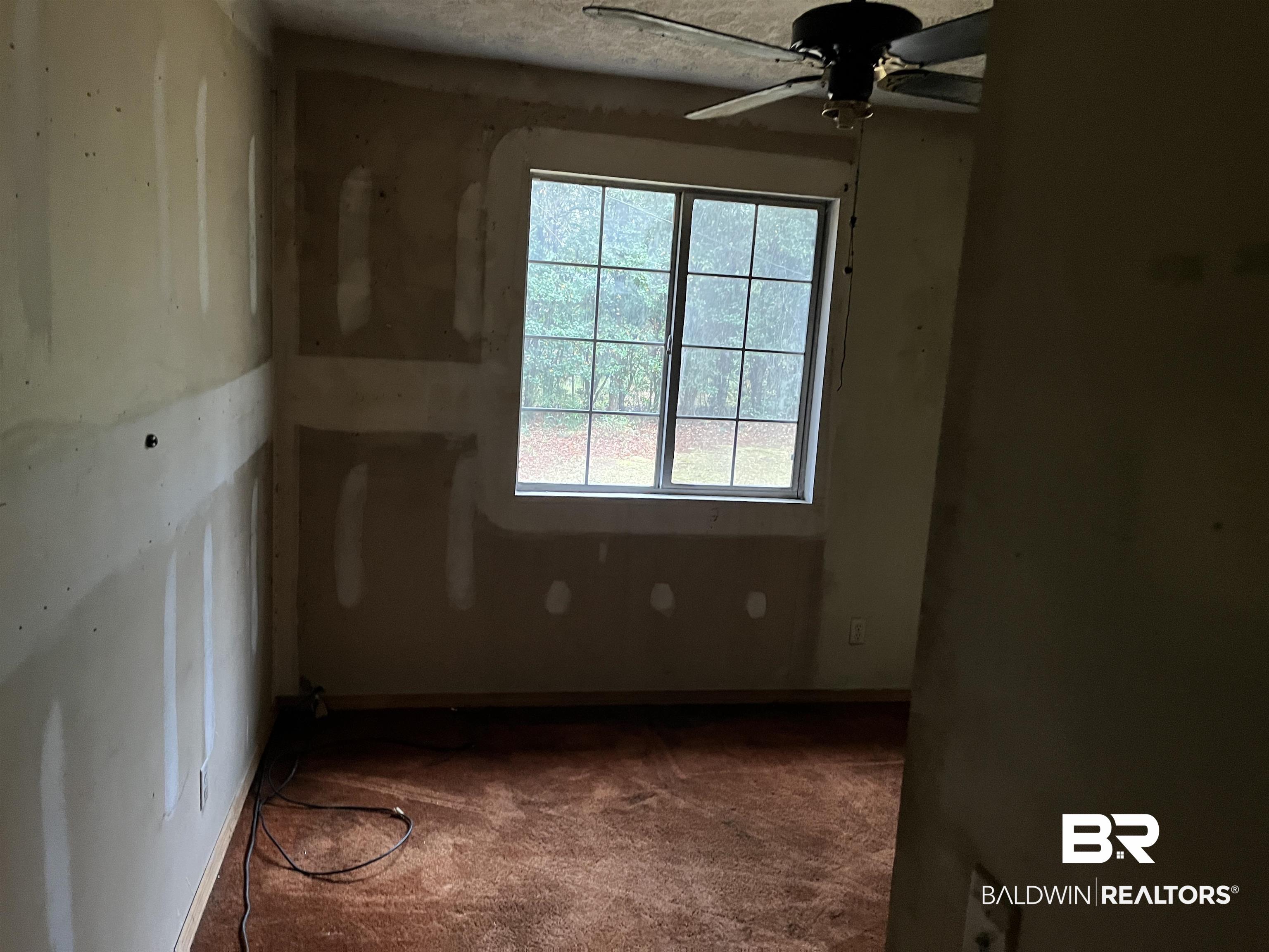 127 Moore Street Brewton, AL 36426 - Photo 10 of 15 Carpeted empty room with a ceiling fan