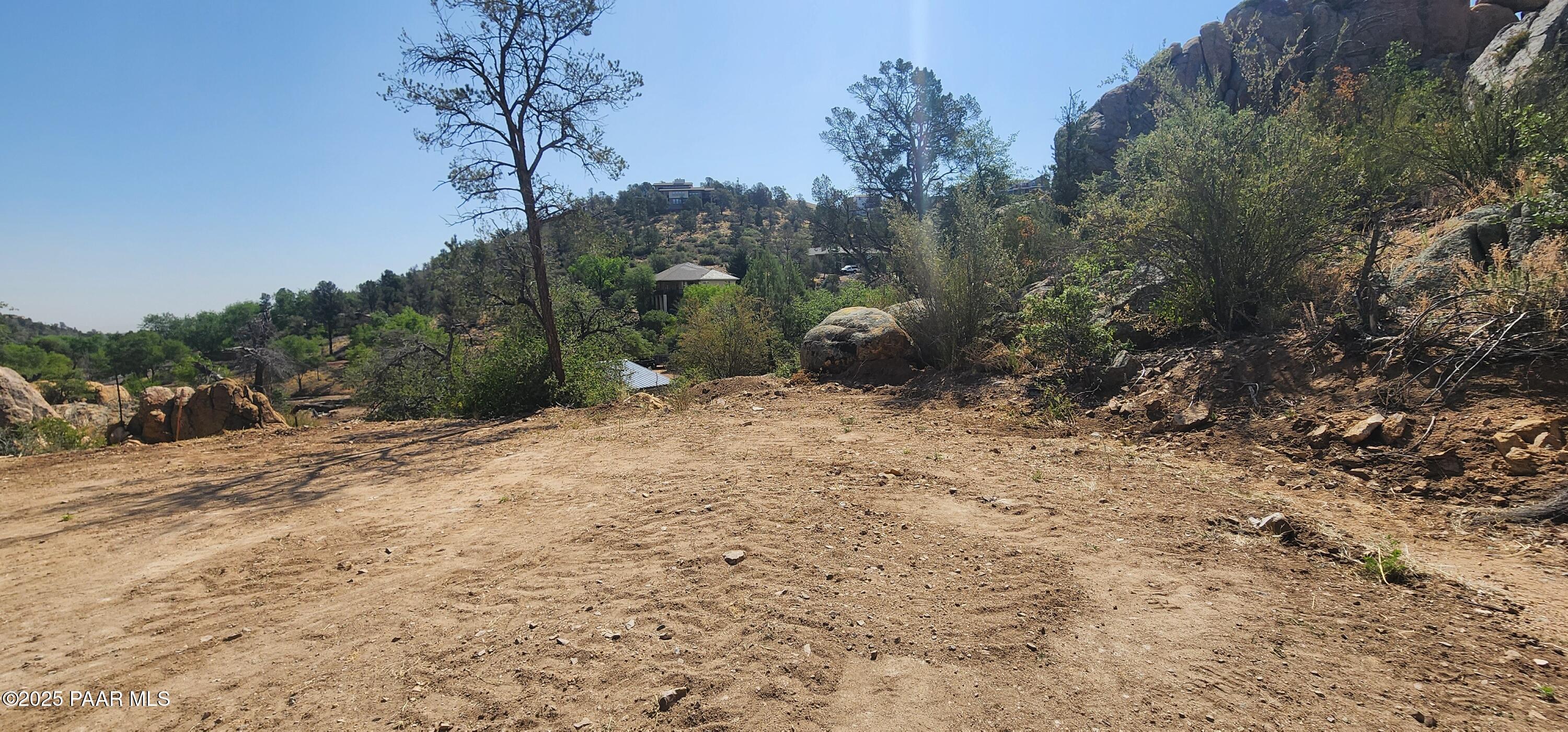2291 Willow Creek Road Prescott, AZ 86301 - Photo 2 of 16 a view of a dry yard with trees