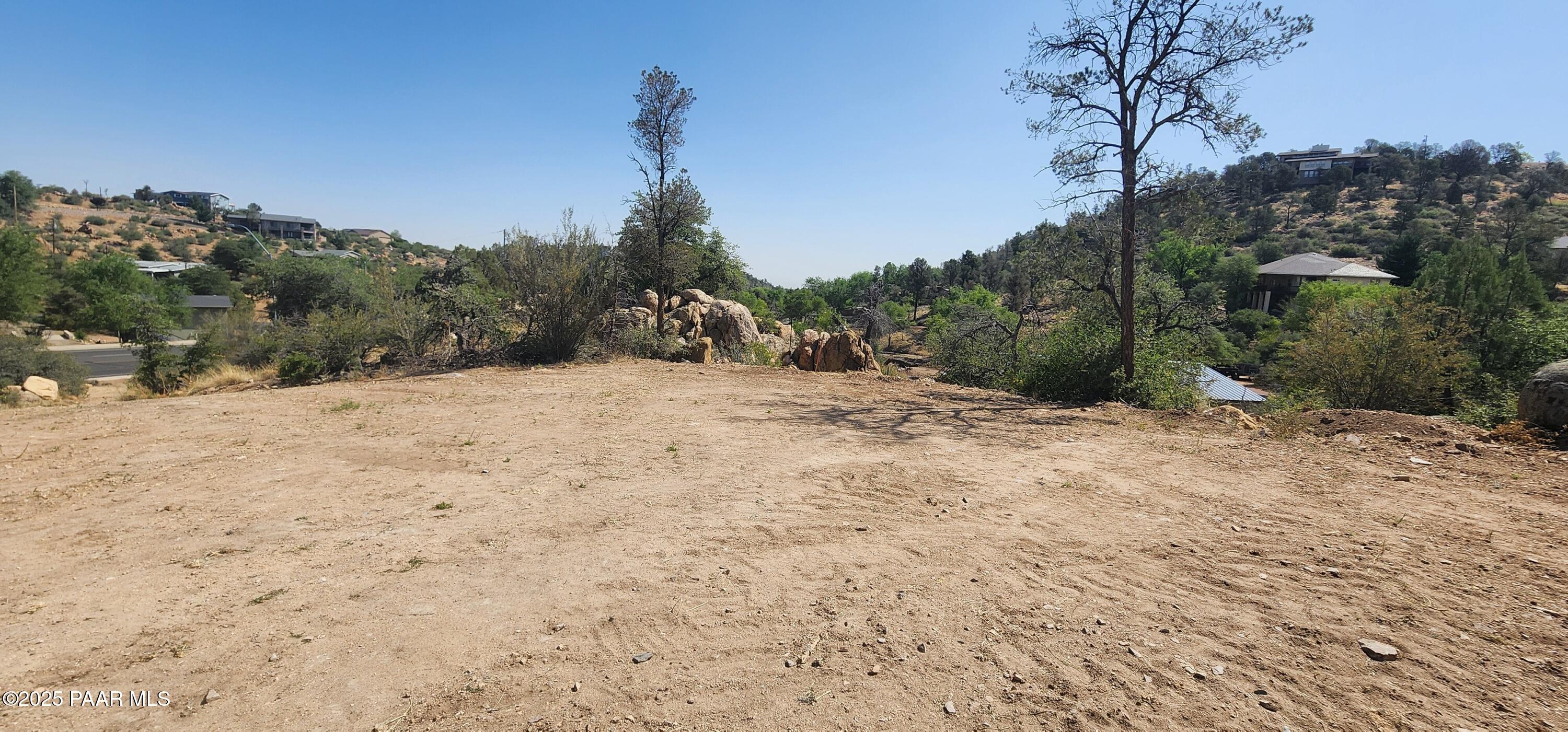 2291 Willow Creek Road Prescott, AZ 86301 - Photo 3 of 16 a view of a dry yard with trees