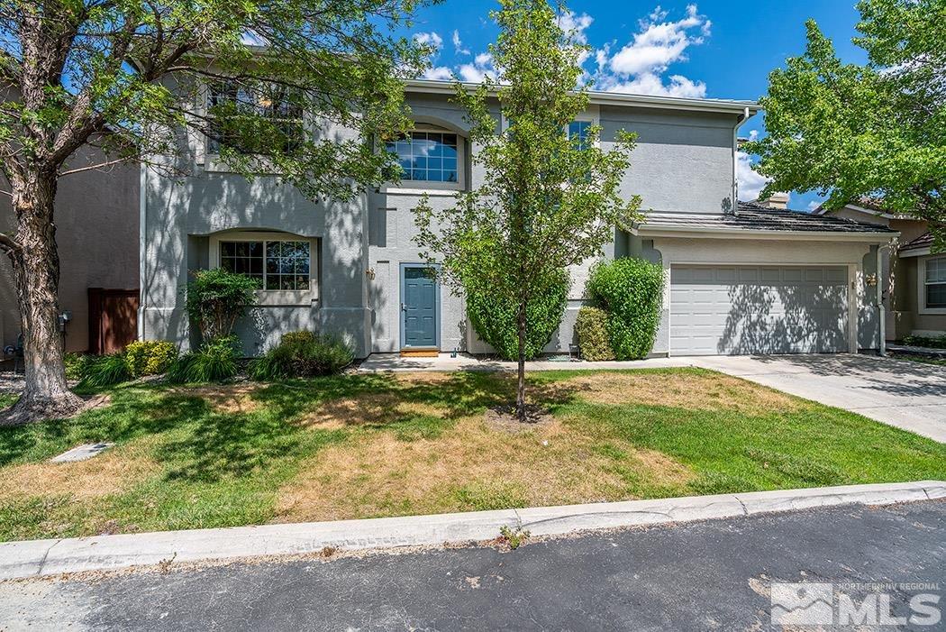 9646 Otter Way Reno, NV 89521 - Photo 1 of 25 a view of a house with a small yard plants and a tree