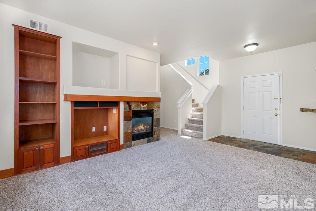 9646 Otter Way Reno, NV 89521 - Photo 7 of 25 a view of an empty room with a fireplace and entryway