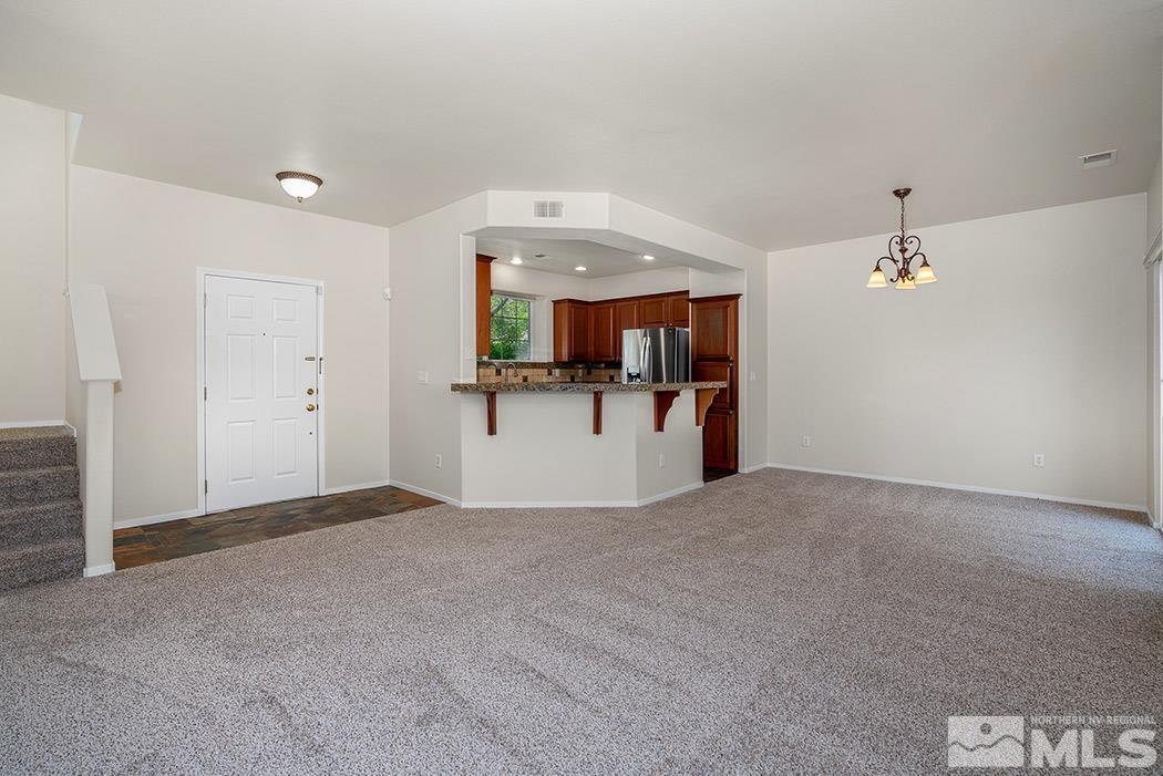 9646 Otter Way Reno, NV 89521 - Photo 9 of 25 a view of a big room with a cabinet and chandelier fan