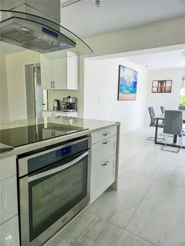 a kitchen with stainless steel appliances a stove and cabinets