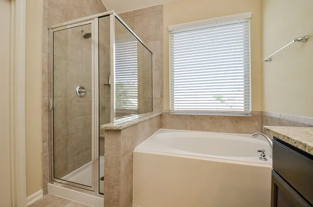 a bathroom with a bathtub and a shower