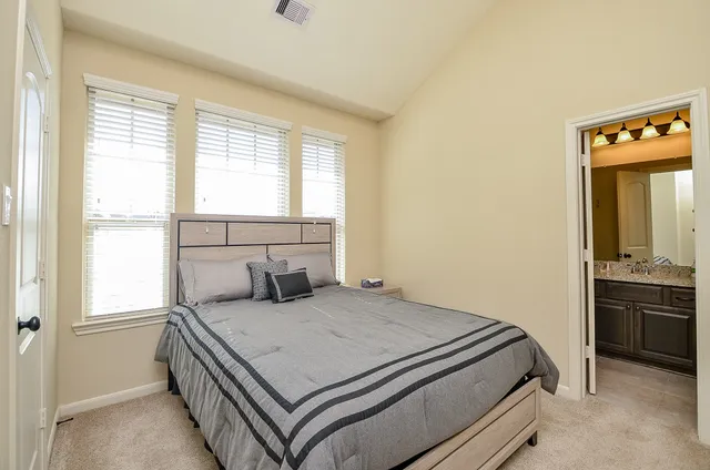 a bedroom with a bed and a window