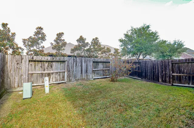 a view of a backyard with a small cabin and a chair