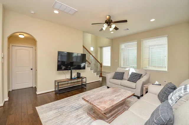 a living room with furniture and wooden floor