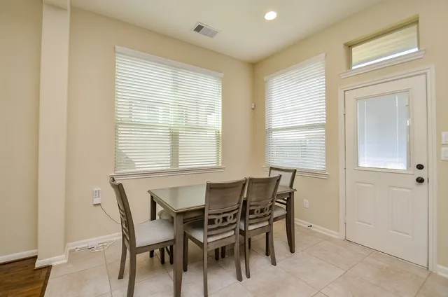 a dining room with furniture and window