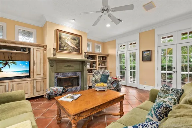 a living room with furniture a flat screen tv and a fireplace