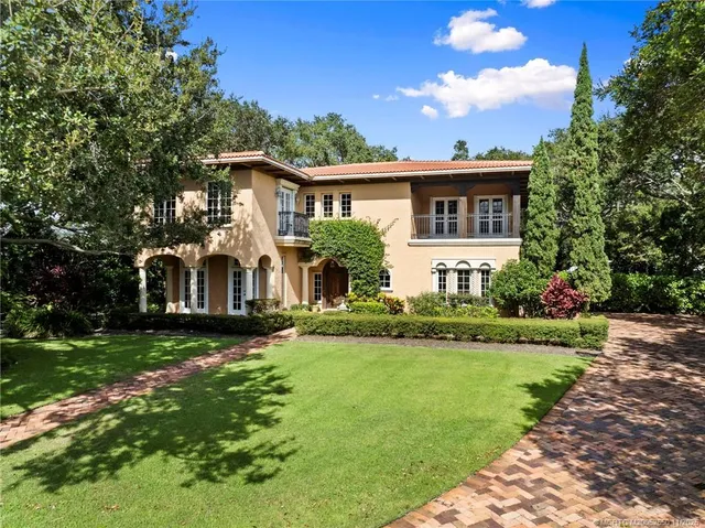 a front view of house with yard and green space
