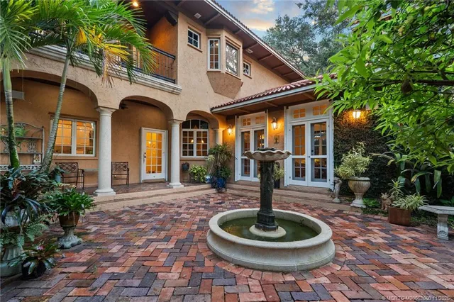 a front view of a house with garden and patio