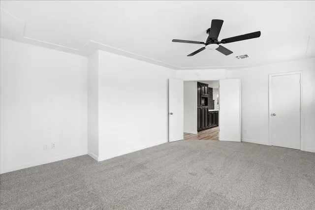 a view of a big room with a ceiling fan and a ceiling fan