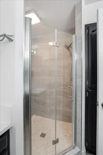 a bathroom with a glass shower door