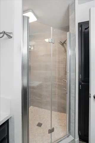 a bathroom with a glass shower door