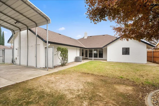 a view of a house with a backyard and floor to ceiling window