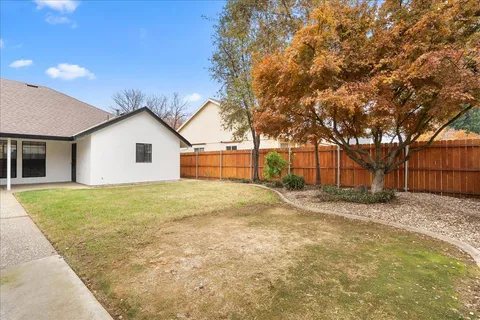 a view of a backyard with large trees