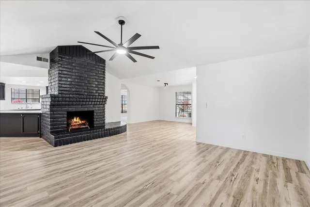 a view of a livingroom with a fireplace and wooden floor
